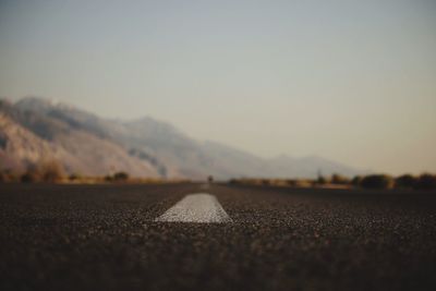 Surface level of road against clear sky