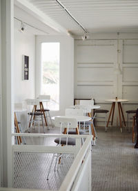 Empty chairs and table in building