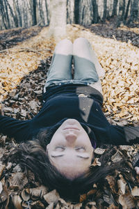 High angle portrait of woman lying on land