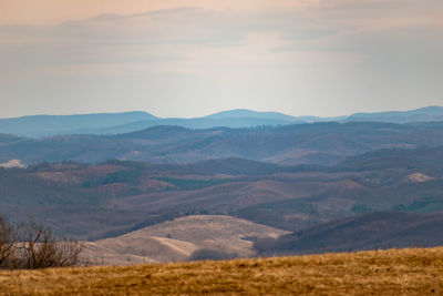 Scenic view of landscape and mountains against sky