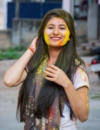 Portrait of smiling young woman standing outdoors