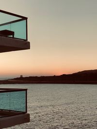 Scenic view of sea against clear sky during sunset