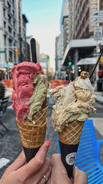 Cropped hand of person holding ice cream cone