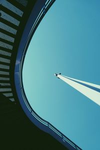 Low angle view of airplane against clear blue sky