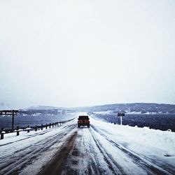 Road passing through snow covered landscape