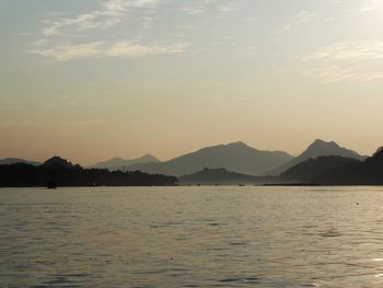 Scenic view of lake against sky during sunset