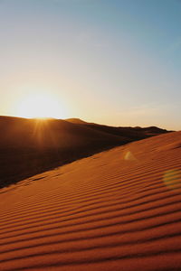 Scenic view of desert against sky during sunset