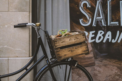 Bicycle with wooden basket against display window