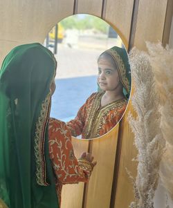 Portrait of smiling omani girl  standing in tent