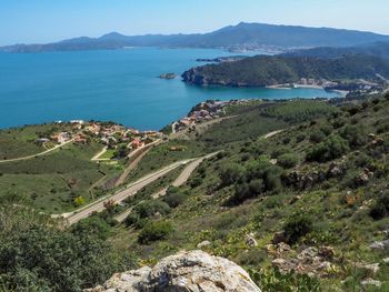 High angle view of sea and mountains against sky