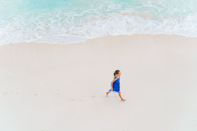 High angle view of girl walking on beach
