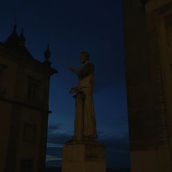 Low angle view of statue in city at night