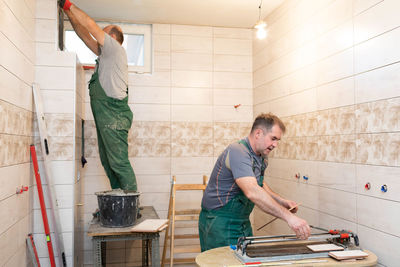 Side view of man working in workshop