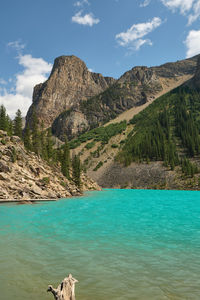 Scenic view of moraine lake and mountains against sky