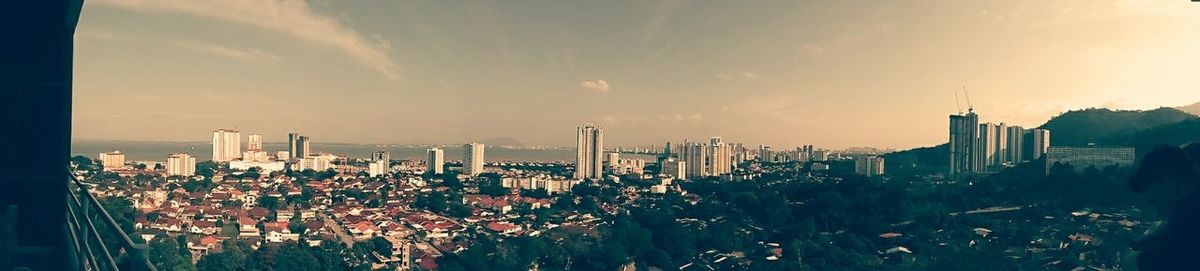 Cityscape against cloudy sky