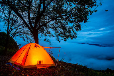 Tent on field against sky