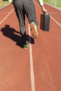 Low section of man running on street