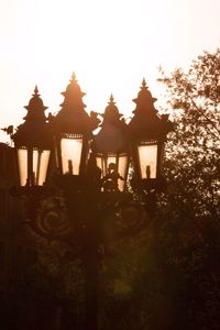 Silhouette built structure against sky at sunset