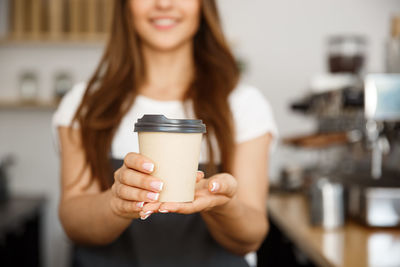 Portrait of young woman drinking coffee