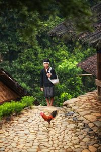 Full length of man standing on footpath