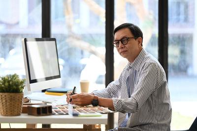Businesswoman using laptop at office