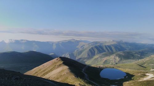 Scenic view of mountains against blue sky