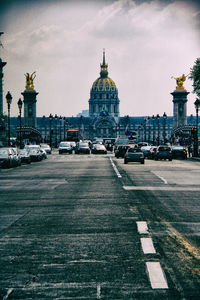 Traffic on road with buildings in background