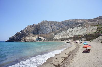 Scenic view of beach against clear blue sky