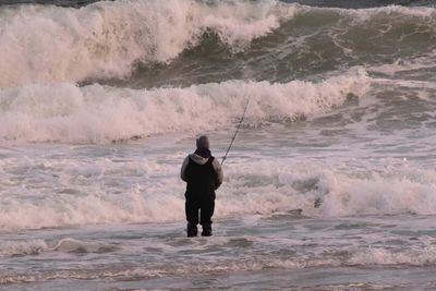 Full length of man fishing in sea