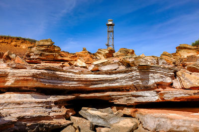 Low angle view of rocks against blue sky