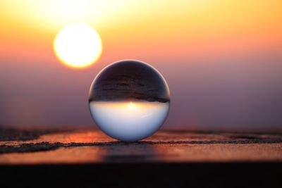 Close-up of crystal ball at sunset