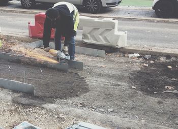 Low section of man skateboarding on street