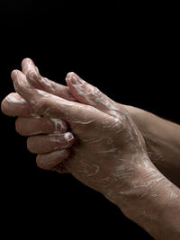 Close-up of man hand over black background