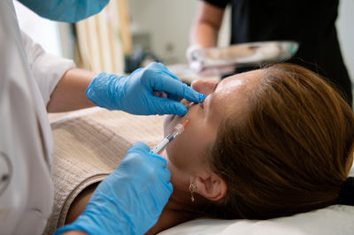 Midsection of doctor examining patient in hospital