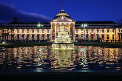 Reflection of building in water at night