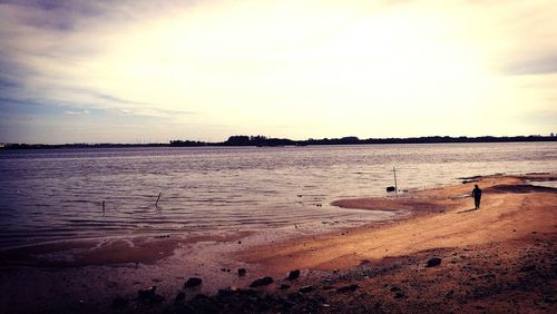 View of calm beach at sunset