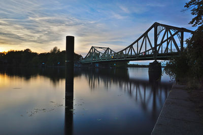 Bridge over river during sunset