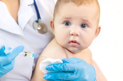 Doctor giving vaccine to baby at clinic