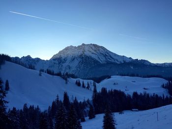 Scenic view of mountains against clear blue sky