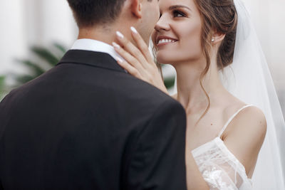 Midsection of couple holding hands