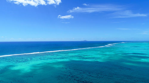 Scenic view of sea against blue sky