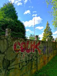 Low angle view of text on tree against sky