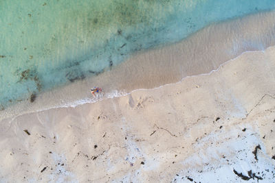 Woman standing on shore at beach