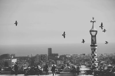 People at park guell against sky