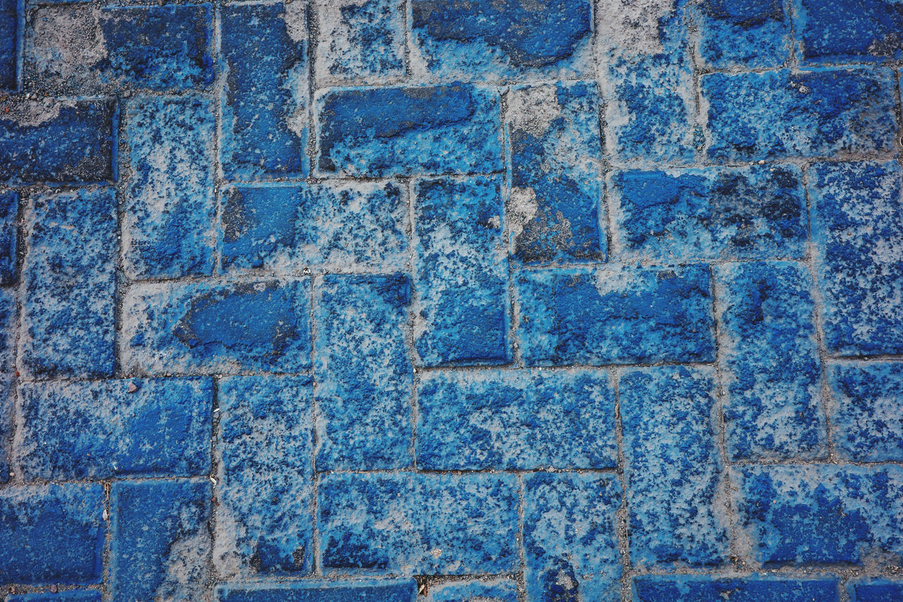 full frame, blue, backgrounds, pattern, wall, no people, textured, art, day, road surface, flooring, wall - building feature, brick, close-up, outdoors, built structure, architecture, rough, brickwork, high angle view