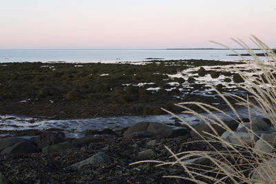 Scenic view of sea against sky at sunset