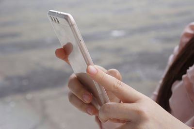 Midsection of person using mobile phone