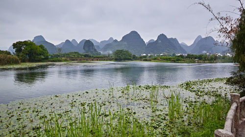 Scenic view of lake and mountains against sky