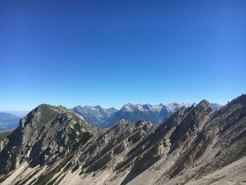 Scenic view of mountains against clear blue sky