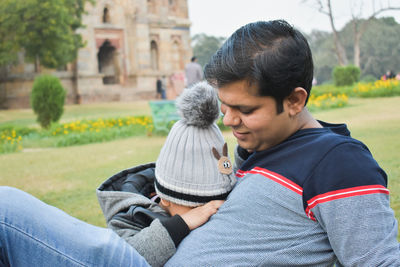 Rear view of couple sitting outdoors